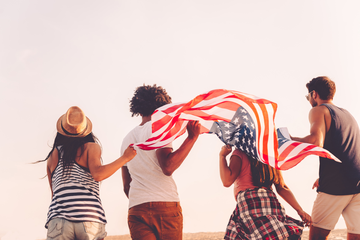 Group of 4 Friends Holding American Flag