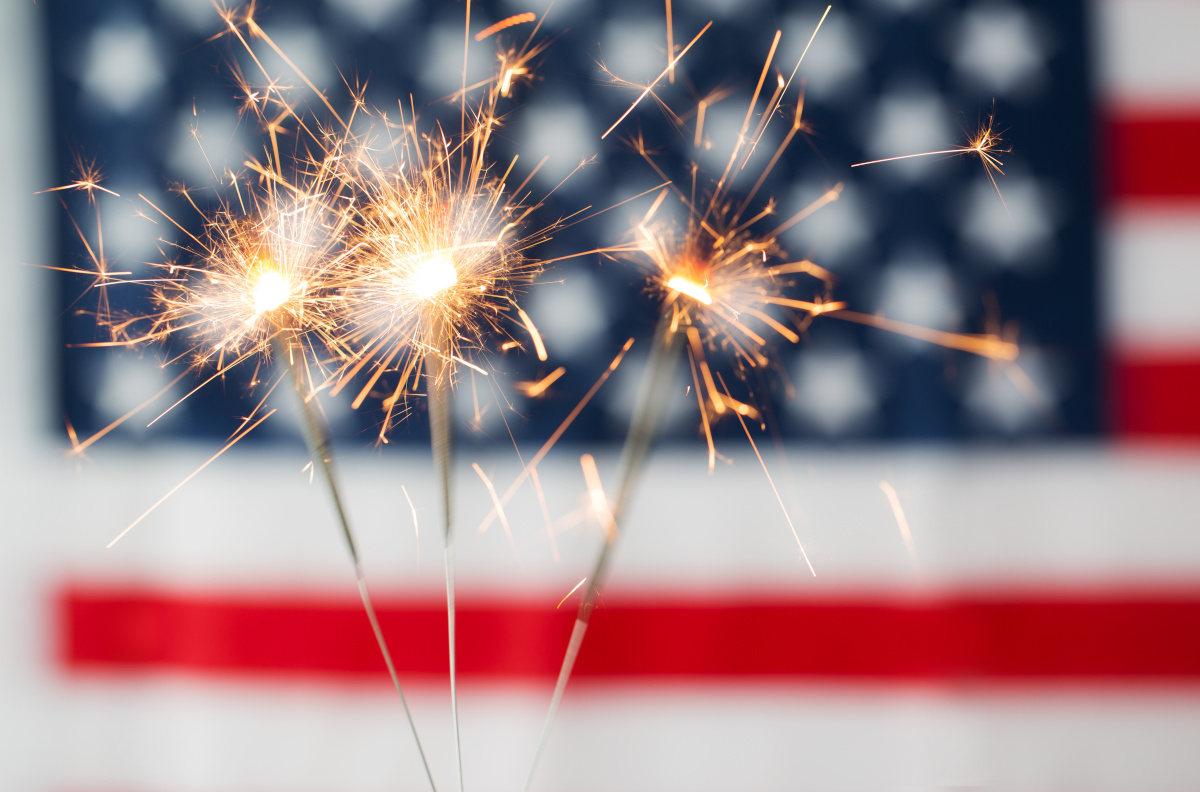 Burning Sparklers with American Flag in Background