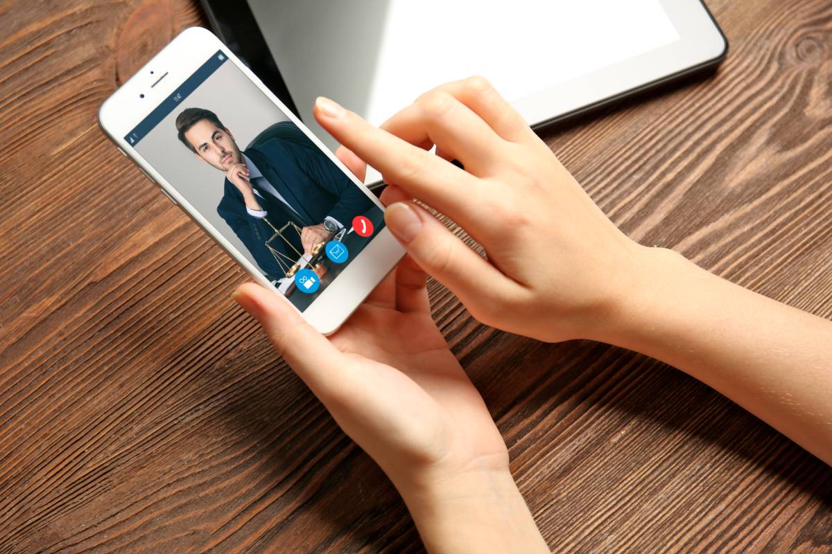 A woman video conferencing with a colleague on her smart phone
