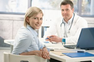 Doctor and patient sitting at a desk