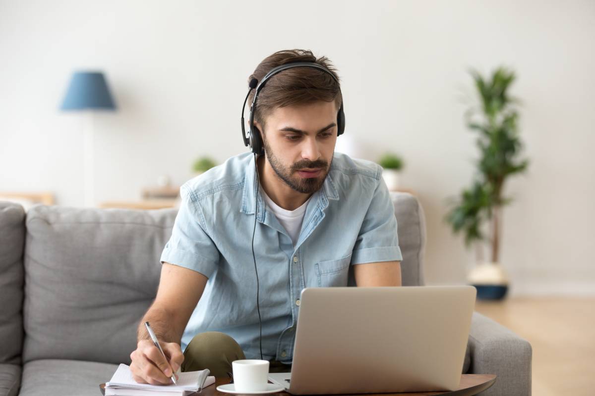 Man working at home using a laptop and headset