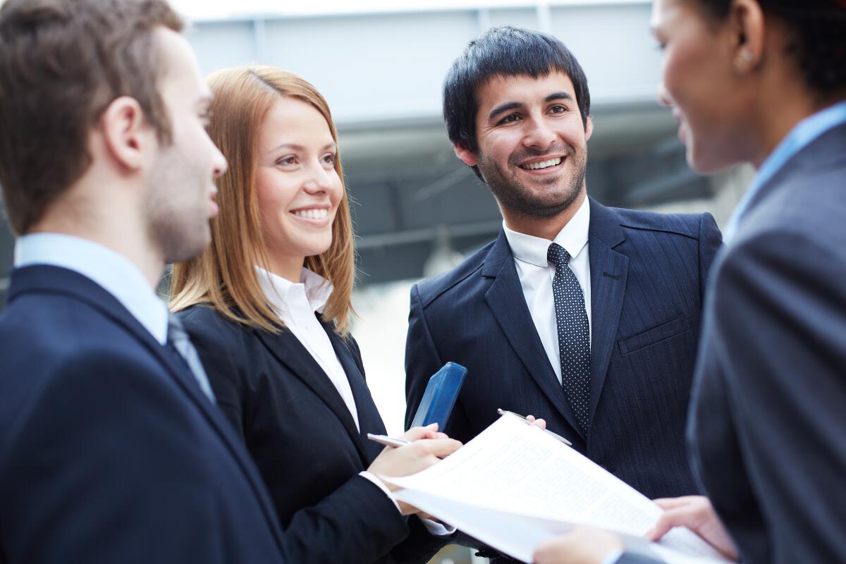 Corporate staff get together and smiling.