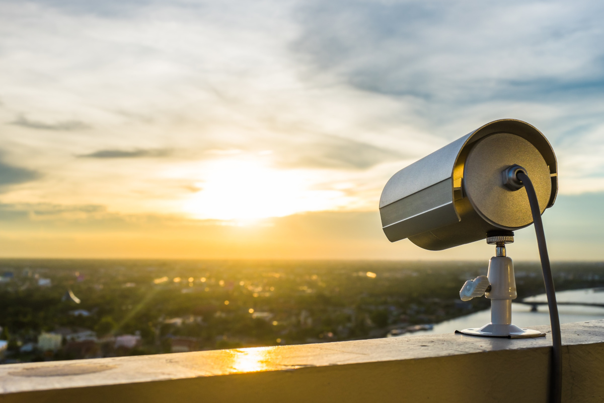 A video surveillance camera on top of a building