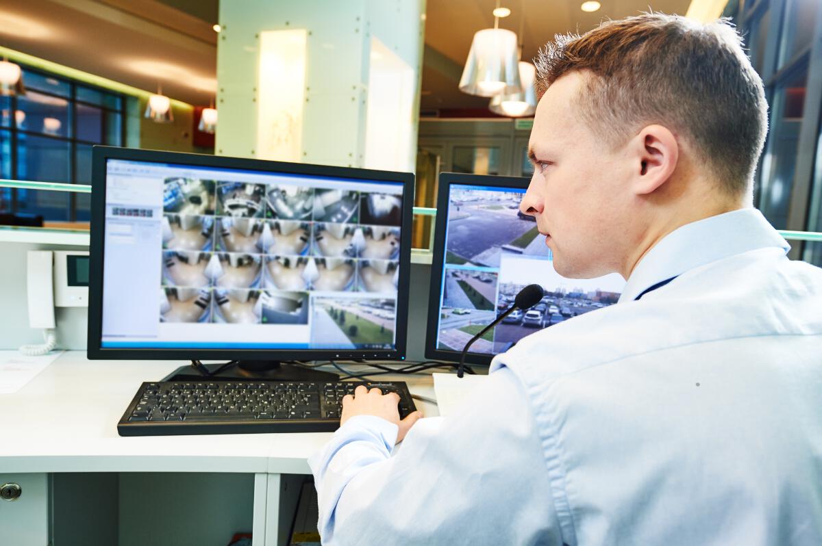 A man watching security camera feeds