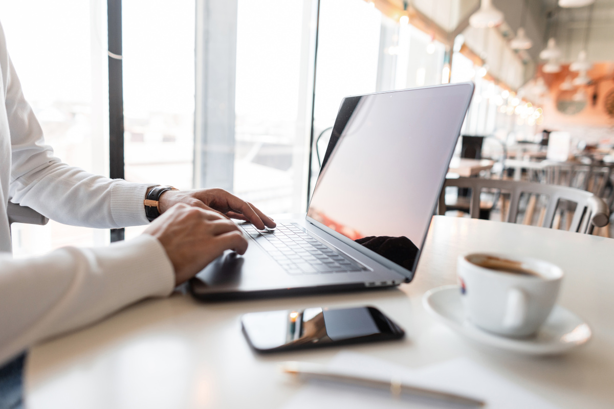 A man working remotely in a coffee shop