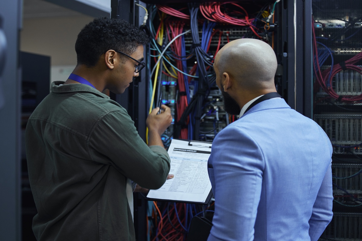 IT Techicians working in server room.