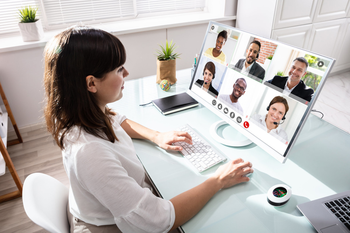 A person on a video conference with coworkers