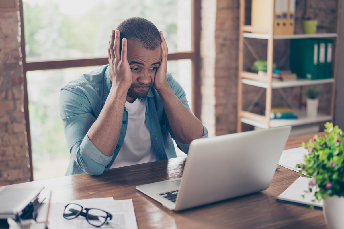 Frustrated man working on computer