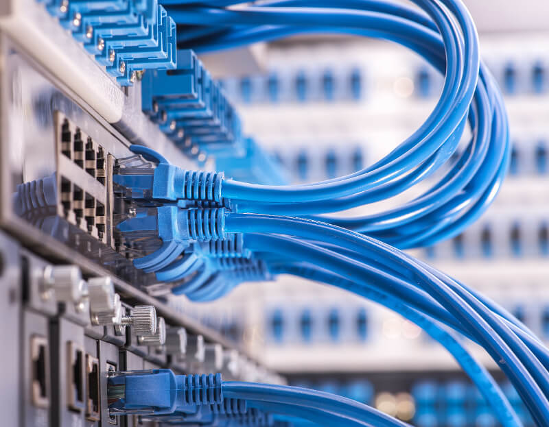 Data cables going into ports on a server rack